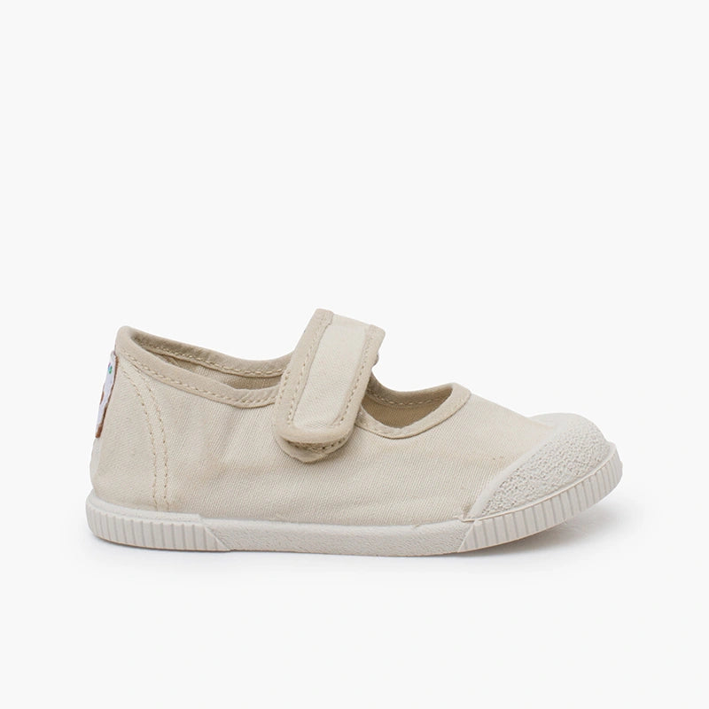 Beige children's shoe with a velcro strap on a white background