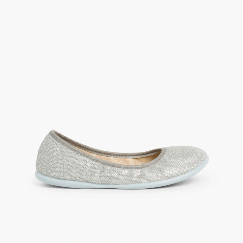 Grey glittery flat shoe on a white background