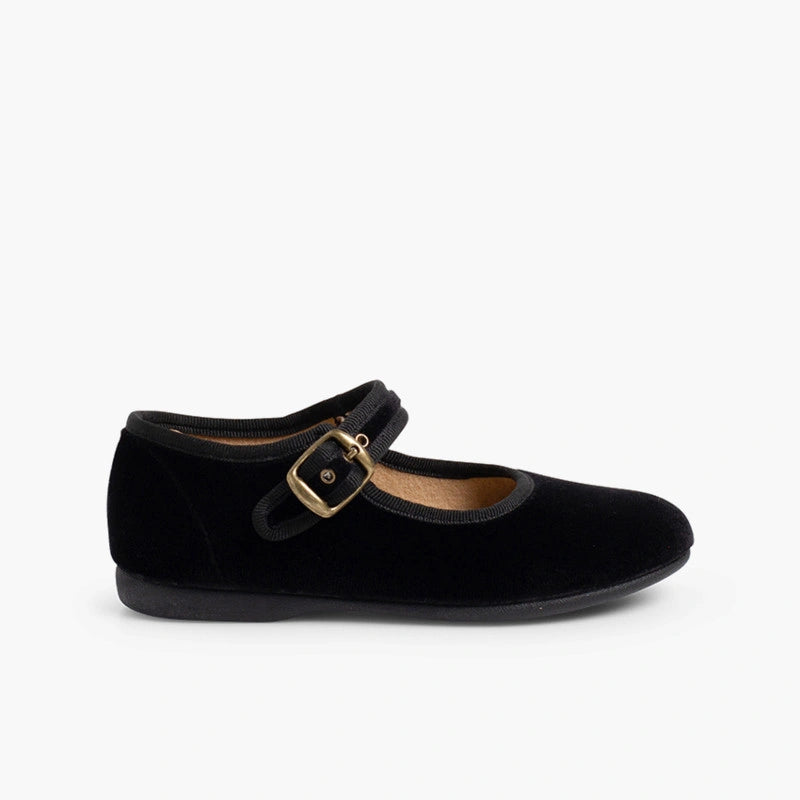 Black shoe with a gold buckle on a white background
