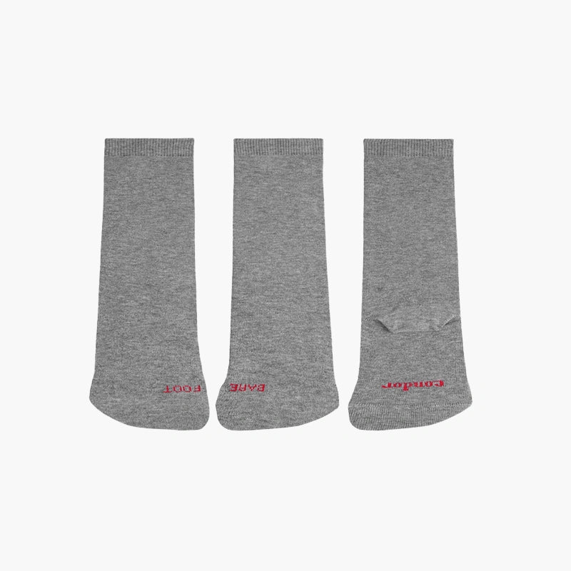 Three pairs of gray knee-high socks with red branding on a white background