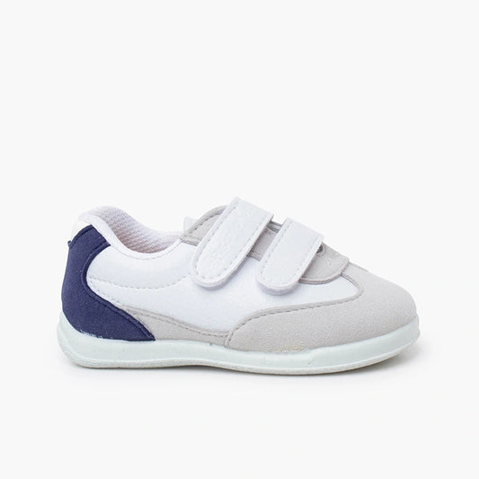 White and blue children's shoe with velcro straps on a white background