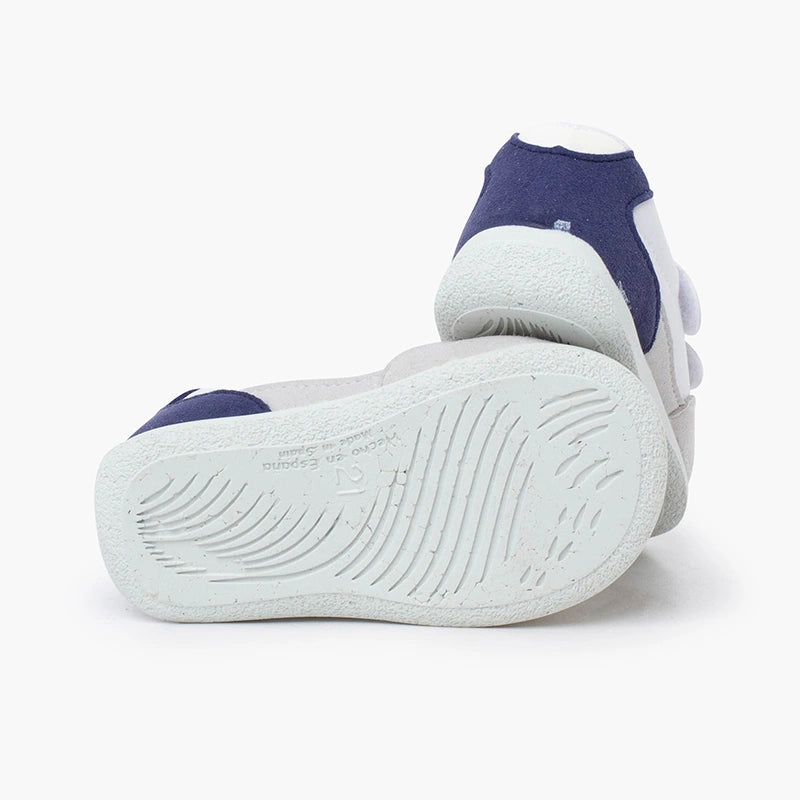 Pair of white sneakers with blue accents on a white background