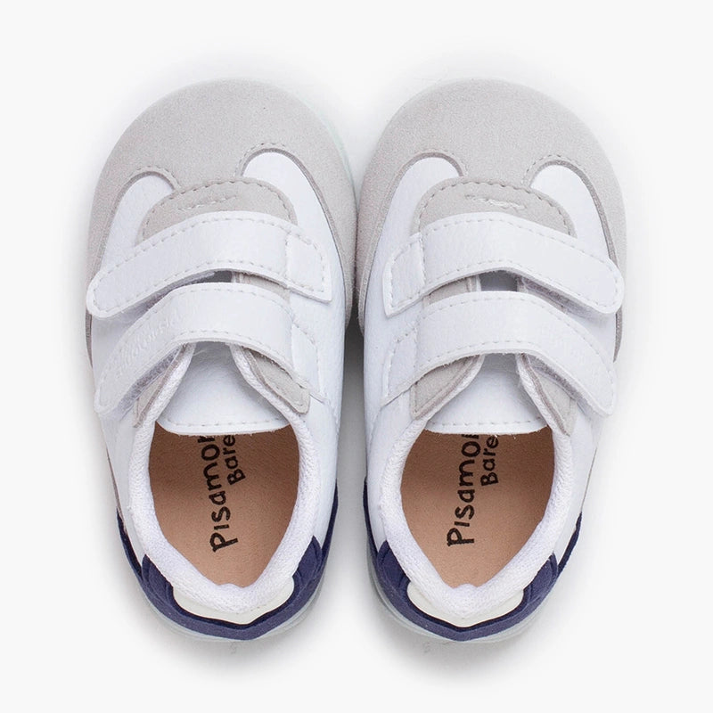 Pair of gray and white sneakers with visible brand name on a white background