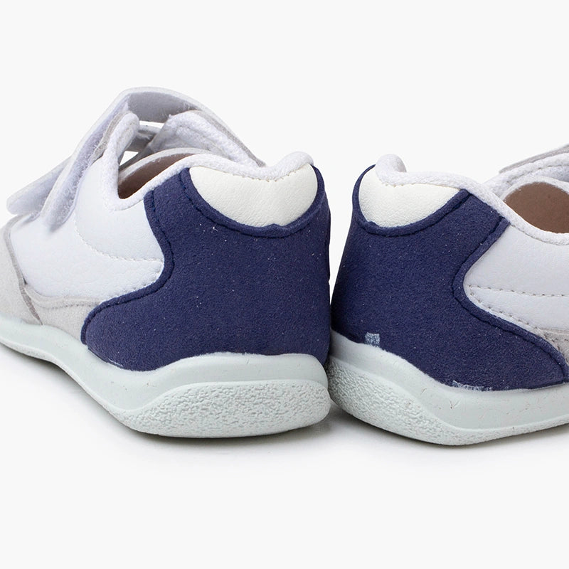 White and blue children's shoes on a white background