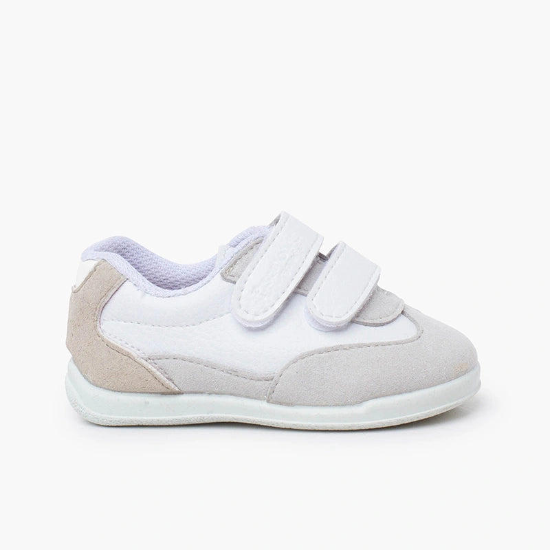 White and beige children's shoe with velcro straps on a white background