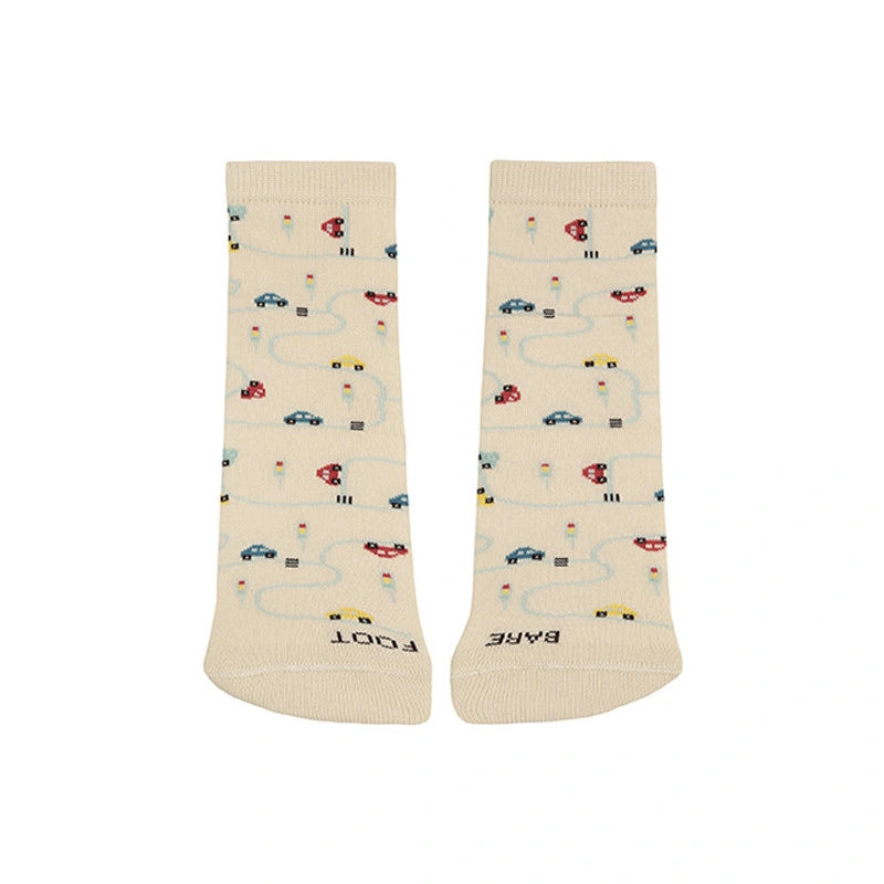 Beige socks with car and road pattern on a white background