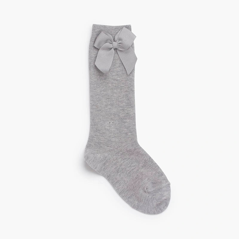 Gray knee-high sock with a bow on a white background
