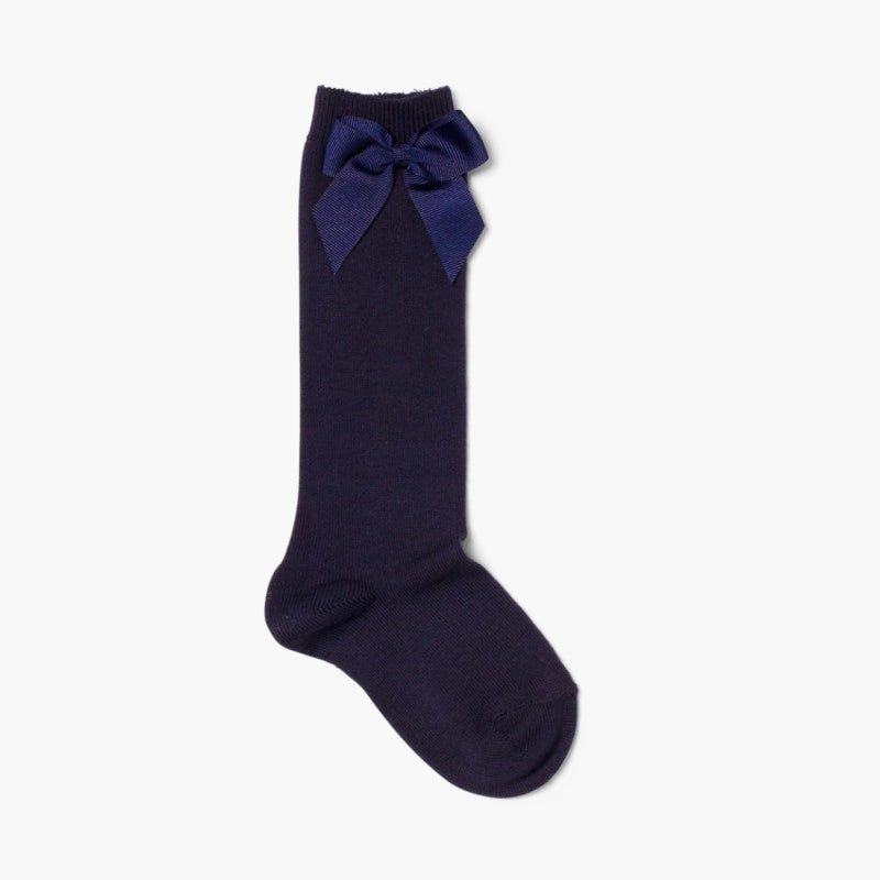 Navy blue knee-high sock with a bow on a white background