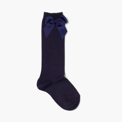Navy blue knee-high sock with a bow on a white background