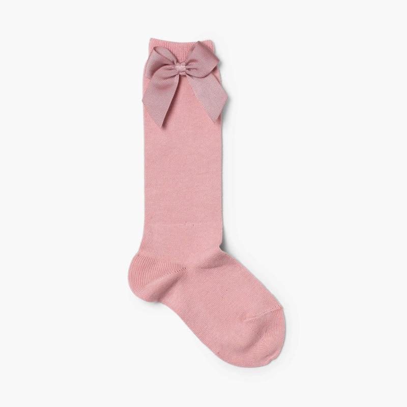 Pink knee-high sock with a bow on a white background