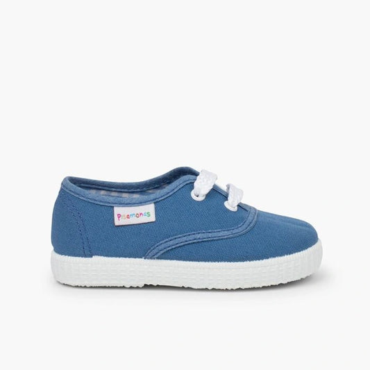 Blue children's sneaker with white sole on a white background