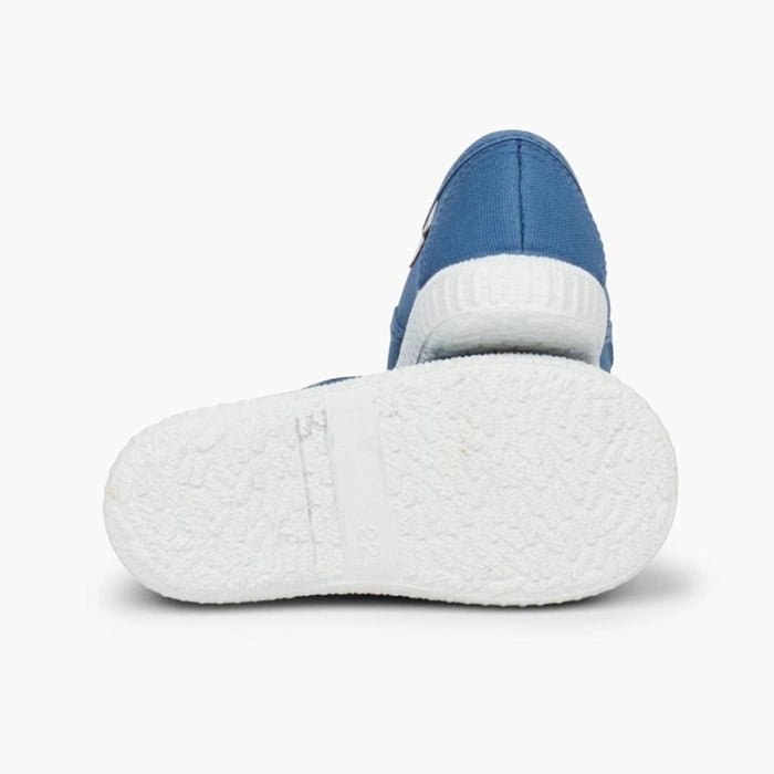 Blue and white slip-on shoe on a light gray background