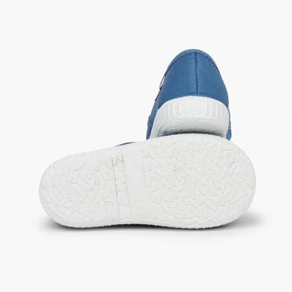 Blue and white slip-on shoe on a light gray background