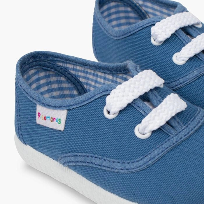 Blue children's shoes with white laces on a white background
