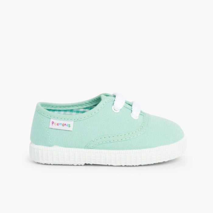 Mint green sneaker with white sole on a white background