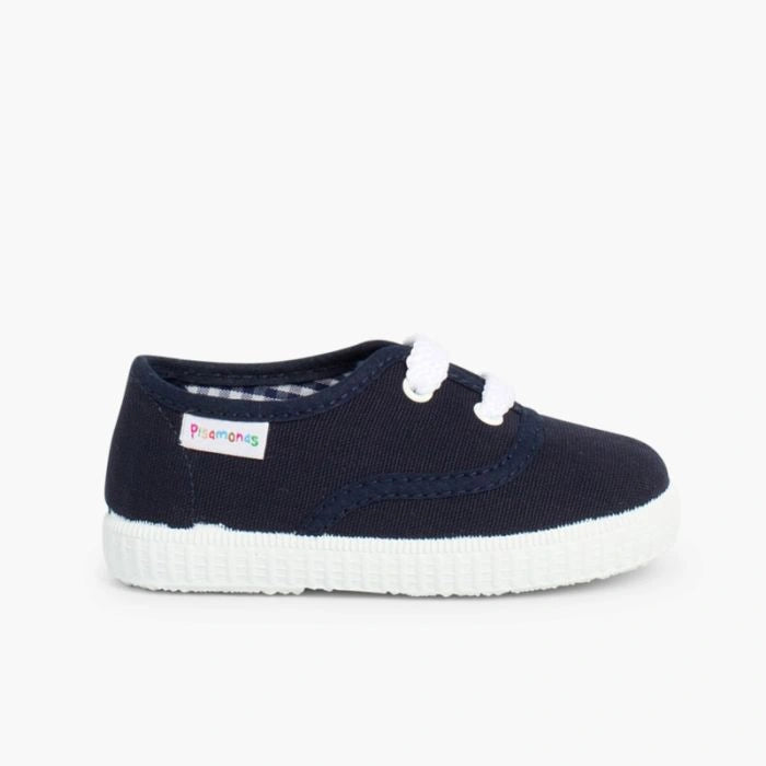 Navy blue shoe with white sole on a light gray background