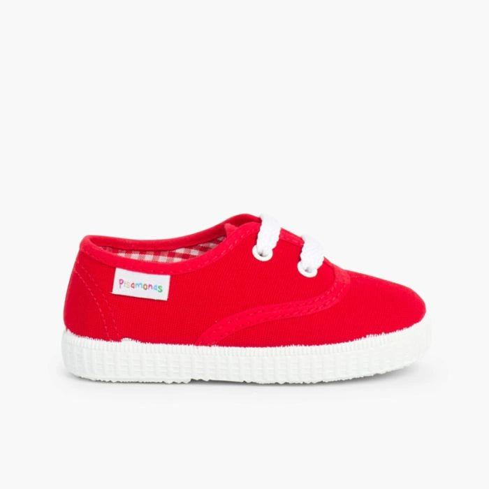Red sneaker with white sole on a white background