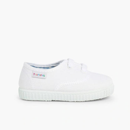 White slip-on shoe with a brand label on a white background