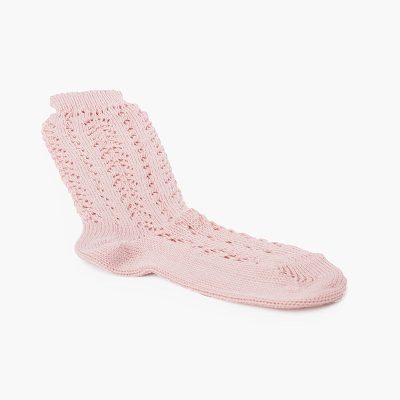 Pink knitted sock on a white background
