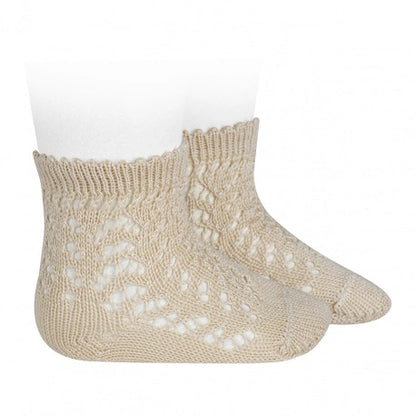 Linen knitted baby socks on a white background