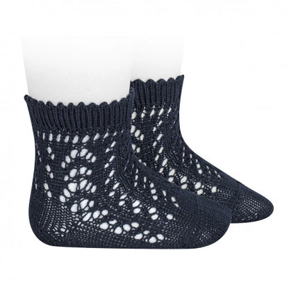 Navy blue knitted socks with openwork pattern on a white background