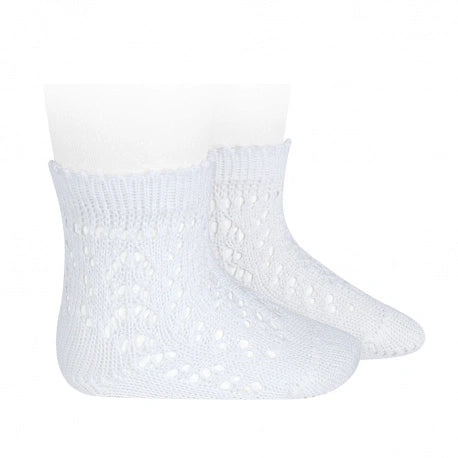 White baby socks with textured pattern on a white background