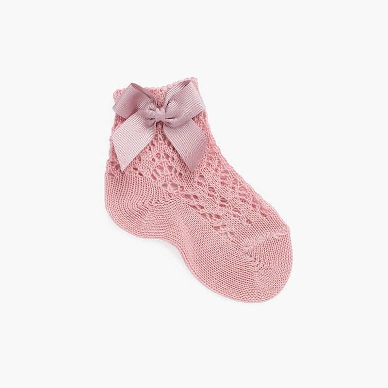 Pink lace sock with a bow on a white background