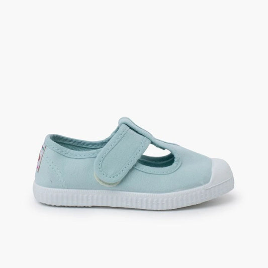 Light blue children's shoe with a white sole on a white background
