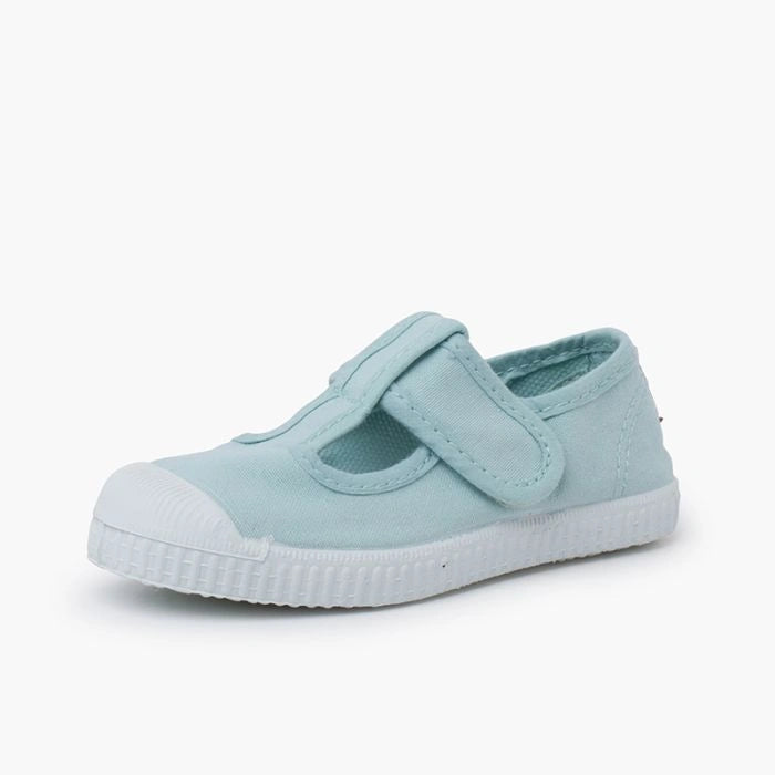 Light blue children's shoe with a white sole on a white background