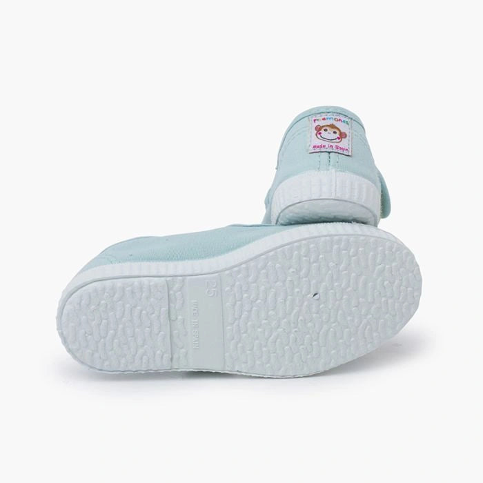 Light blue children's shoe with a white sole on a white background