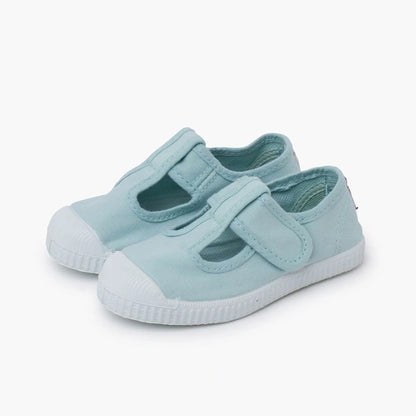 Light blue children's shoe with a white sole on a white background