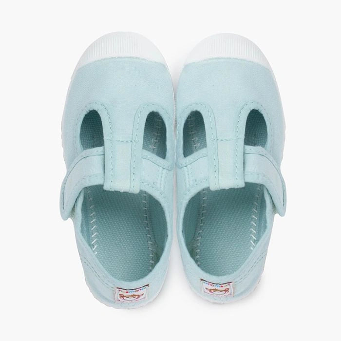 Light blue children's shoe with a white sole on a white background