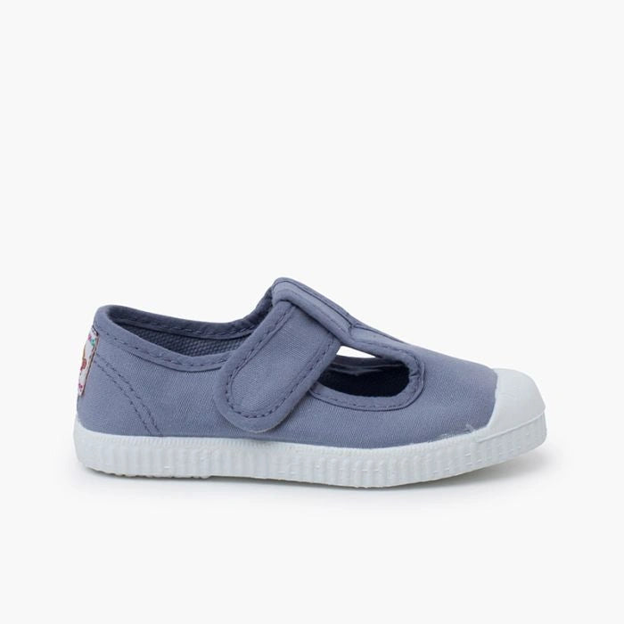 Blue children's shoe with a white sole on a white background