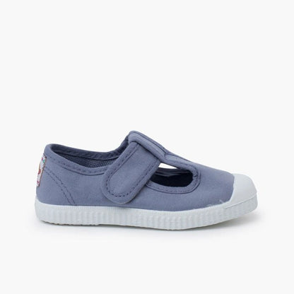 Blue children's shoe with a white sole on a white background