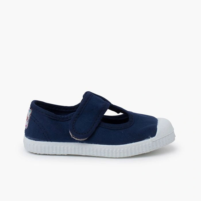 Navy blue shoe with a white sole on a white background