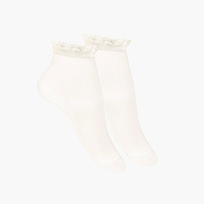Beige socks with lace top on a white background